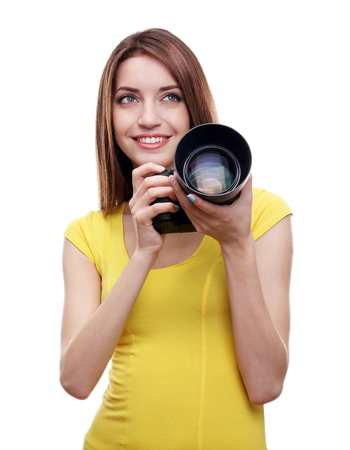 Young female photographer taking photos isolated on white