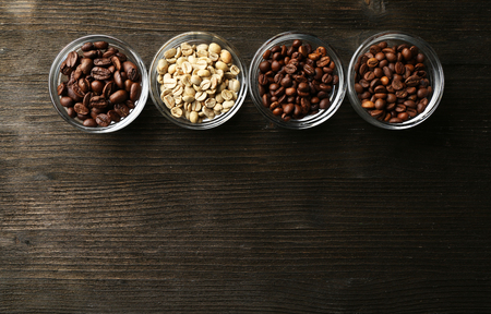 Coffee beans in saucers on wooden backgroundの写真素材