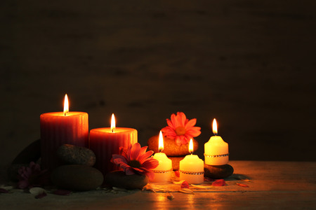 Beautiful composition with candles and spa stones on wooden backgroundの写真素材