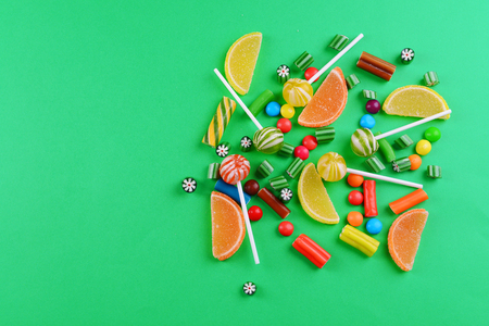 Colorful candies on green backgroundの写真素材