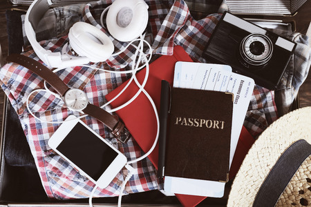 Packed suitcase of vacation items, top view