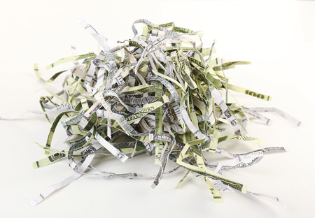 Destroyed money from shredder isolated on whiteの写真素材