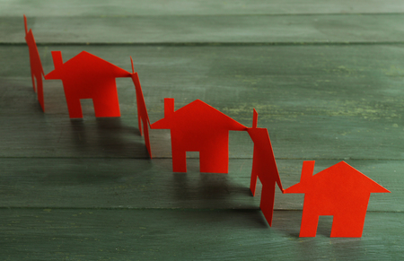 Paper houses on wooden backgroundの写真素材