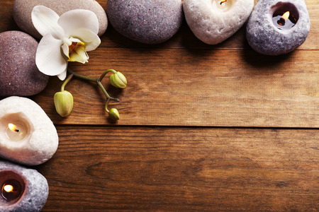 Spa stones and orchid flower on wooden backgroundの写真素材