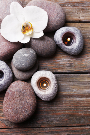 Spa stones and orchid flower on wooden backgroundの写真素材