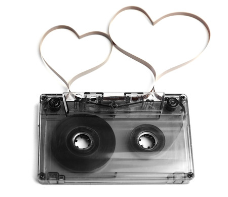 Audio cassette with magnetic tape in shape of hearts isolated on whiteの写真素材