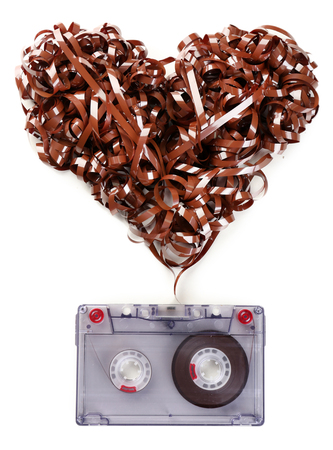 Audio cassette with magnetic tape in shape of heart isolated on whiteの写真素材