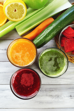 Assortment of healthy fresh juices on wooden table backgroundの写真素材