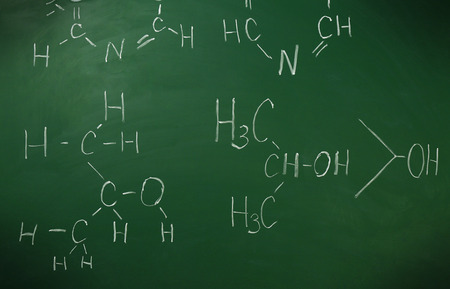Molecule models and formulas on blackboard backgroundの写真素材