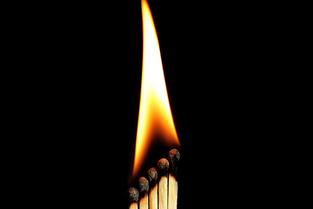 Burning matches on dark background