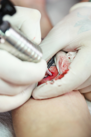 Tattoo artist at work, close-upの写真素材