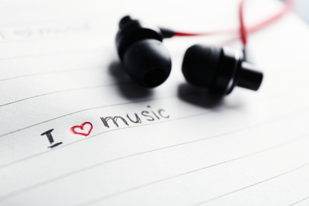 Earphones on notebook with text I Love Music, closeupの写真素材