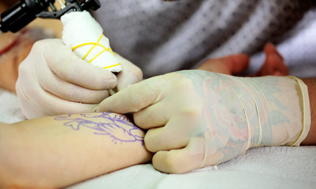 Tattoo artist at work, close-upの写真素材