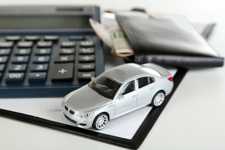 Tablet, calculator and toy car isolated on whiteの写真素材