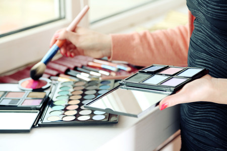 Female makeup artist with cosmetics at work close-upの写真素材