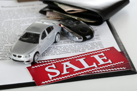 Tablet, purse and toy car isolated on whiteの写真素材