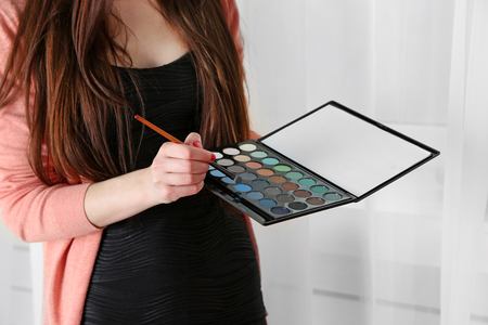Female makeup artist with cosmetics at work close-upの写真素材