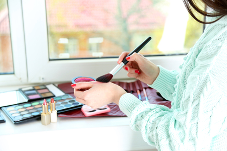 Female makeup artist with cosmetics at work close-upの写真素材