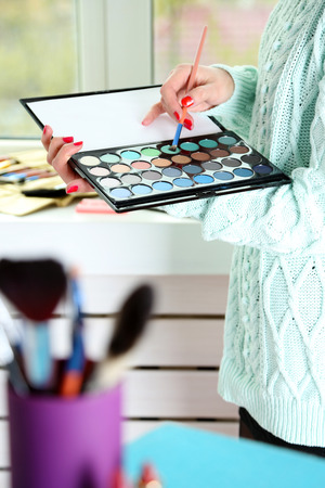 Female makeup artist with cosmetics at work close-upの写真素材