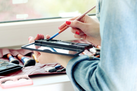 Female makeup artist with cosmetics at work close-upの写真素材