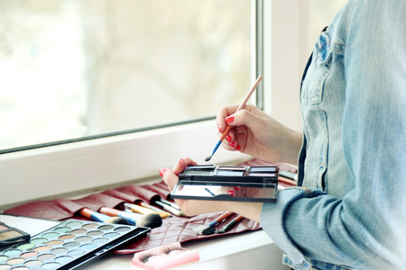 Female makeup artist with cosmetics at work close-upの写真素材