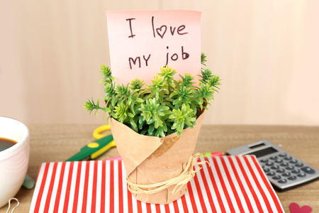 Inscription I love my job in flowerpot on workplaceの写真素材