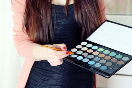 Female makeup artist with cosmetics at work close-upの写真素材