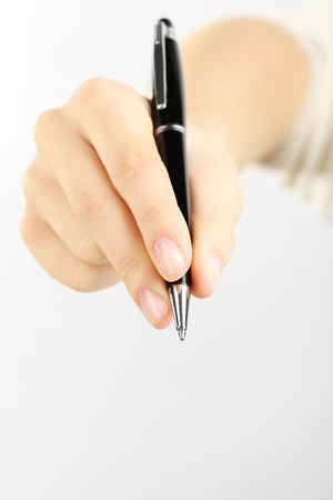 Female hand with pen isolated on whiteの写真素材