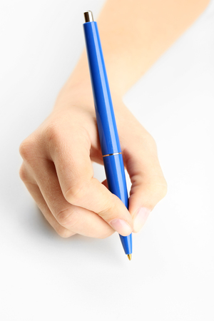 Female hand with pen isolated on whiteの写真素材