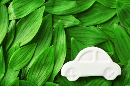 Toy car on green leaves backgroundの写真素材
