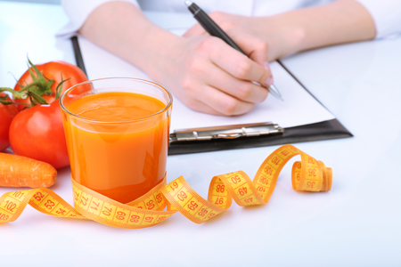Nutritionist Doctor writing  diet plan in office, closeupの写真素材