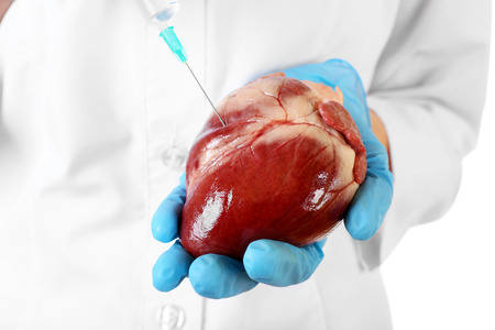 Doctor hand makes injection into heart, closeupの写真素材