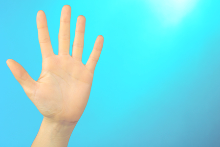 Female hand on colorful backgroundの写真素材