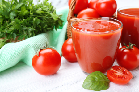 Glasses of fresh tomato juice on wooden table, closeupの写真素材
