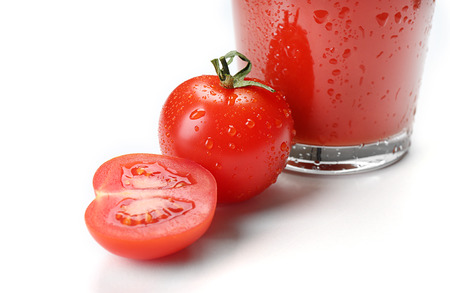 Glass of fresh tomato juice isolated on whiteの写真素材
