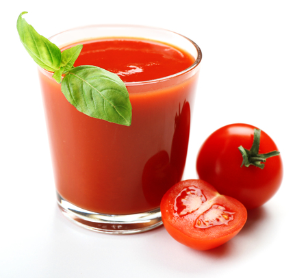 Glass of fresh tomato juice isolated on whiteの写真素材