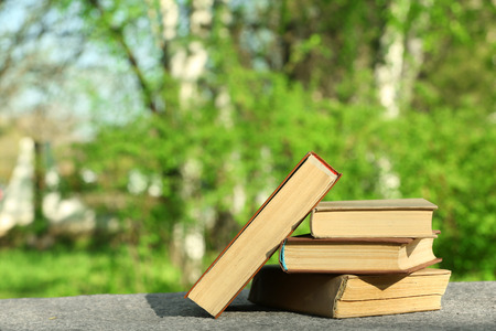 Stack of books outdoors, on blurred backgroundの写真素材