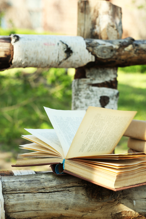 Stack of books on bench, outdoorsの写真素材