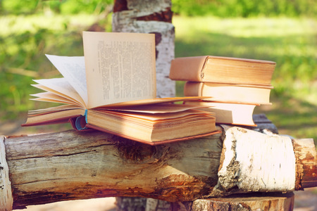 Stack of books on bench, outdoorsの写真素材