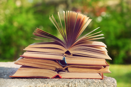 Stack of books outdoors, on blurred backgroundの写真素材
