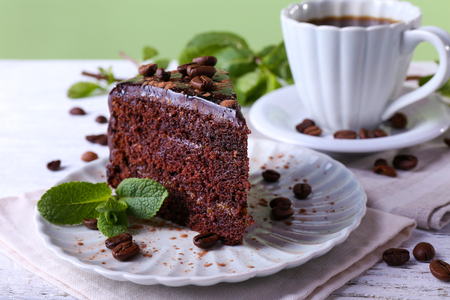 Delicious chocolate cake with mint on plate on table close upの写真素材