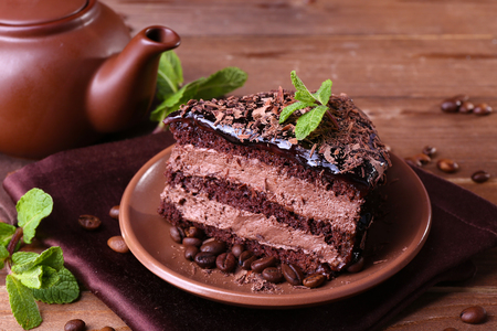 Delicious chocolate cake with mint on plate on table close upの写真素材