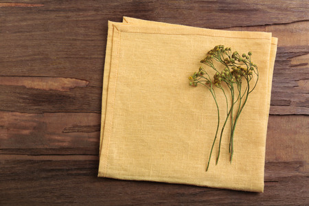 Beautiful dry flowers on napkin on wooden backgroundの写真素材