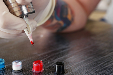 Tattoo artist at work close upの写真素材