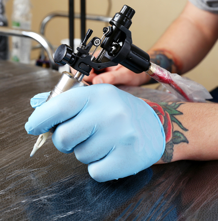 Tattoo artist at work close upの写真素材