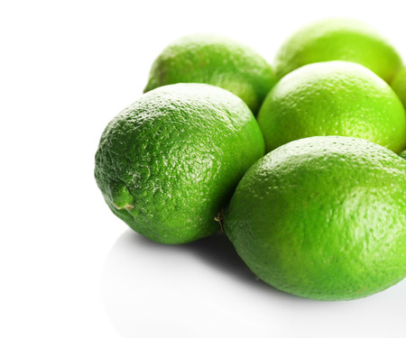 Group of fresh limes isolated on whiteの写真素材
