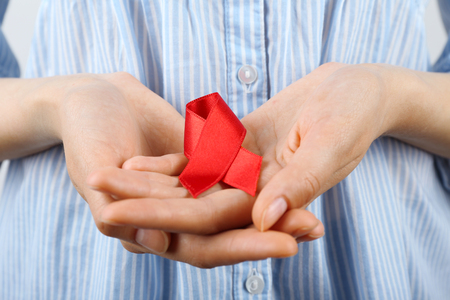 Female hands with color ribbon, closeupの写真素材