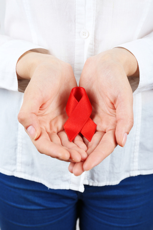Female hands with color ribbon, closeup
