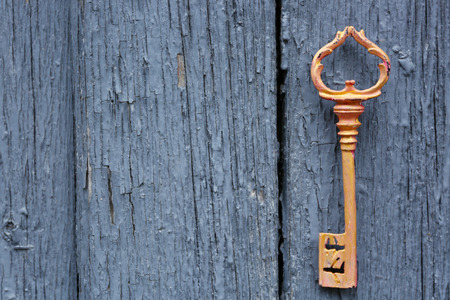 Old key on wooden antique door close-upの写真素材