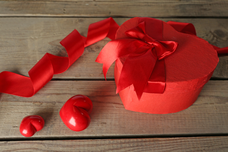 Heart shaped Valentines Day gift box, on wooden tableの写真素材